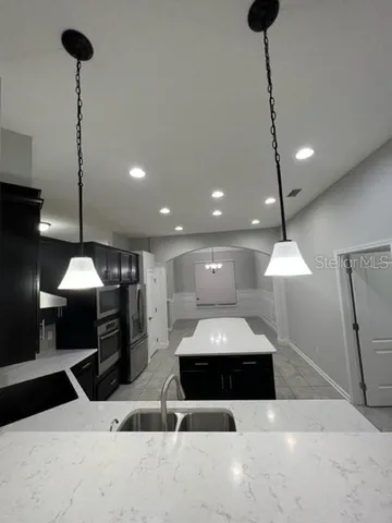 an empty room with a empty space and windows