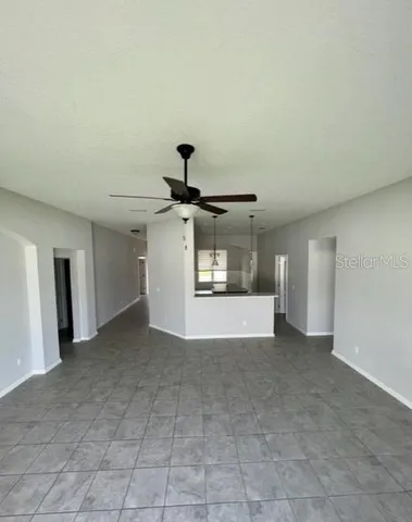 an empty room with a empty space and windows