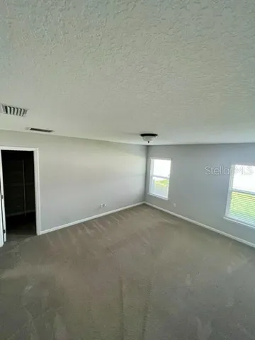 an empty room with a empty space and windows