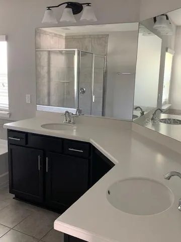 a bathroom with a double vanity sink and mirror