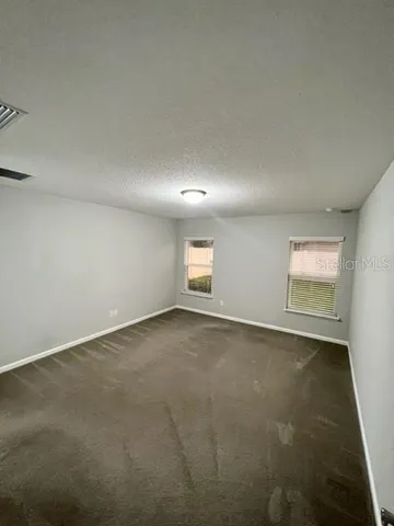 a view of a house with yard and a garden