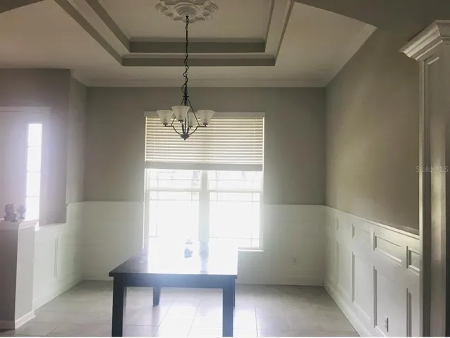 a living room with furniture plant and a window