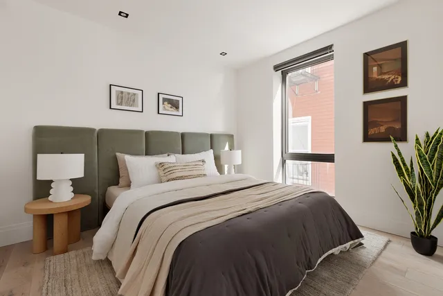 a bedroom with a bed and a chair