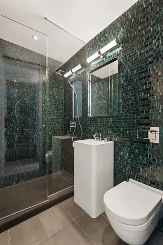 a bathroom with a toilet and a shower