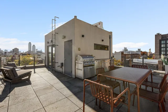a view of a patio with dining table and chairs