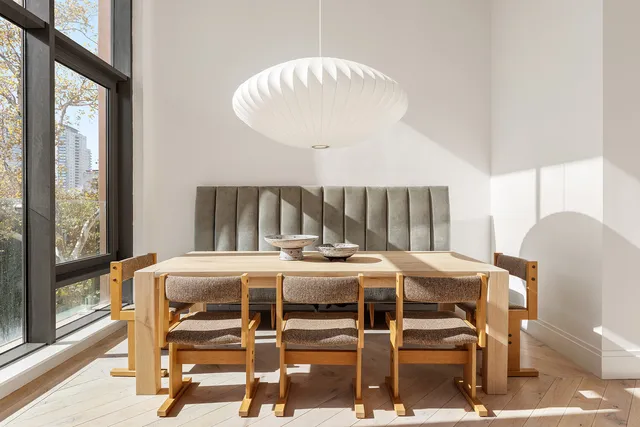 a kitchen with a sink and chairs