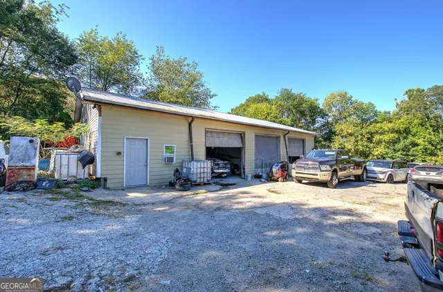 a view of a house with backyard and sitting area
