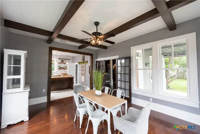 a dining room with furniture a rug and a large window