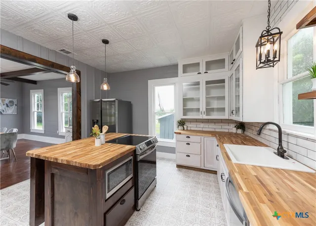 a kitchen with a sink stove and view living room