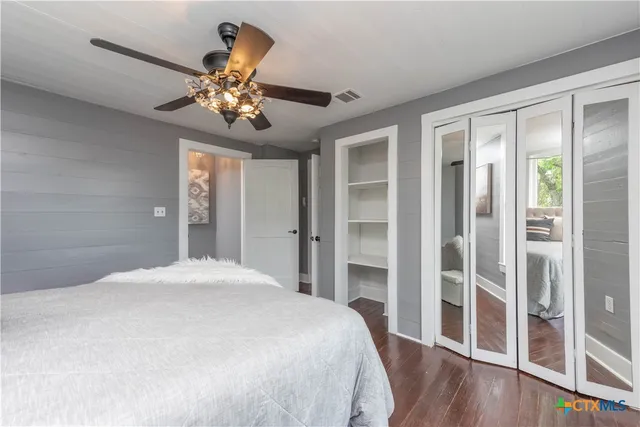 a bedroom with a bed and a chandelier