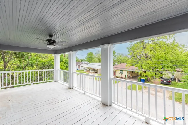 a view of a balcony with wooden floor