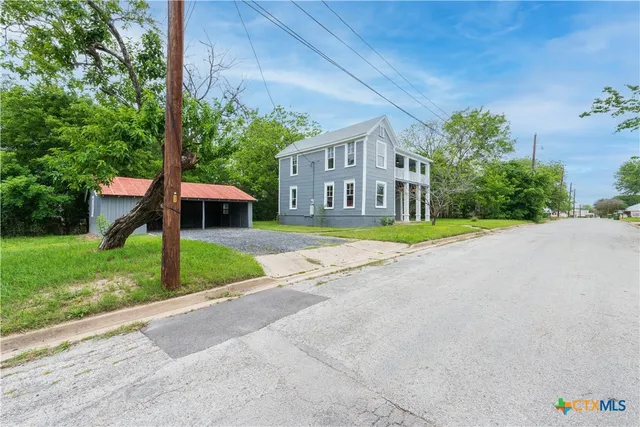 a front view of a house with a yard and porch