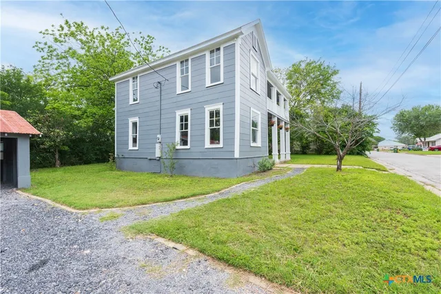 a front view of a house with a yard