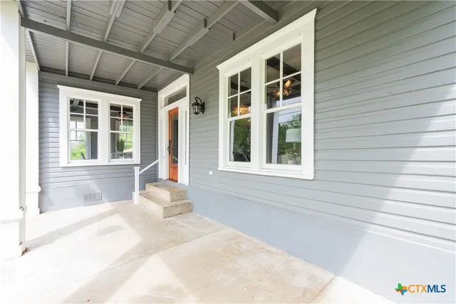 a bathroom with sink window and couch