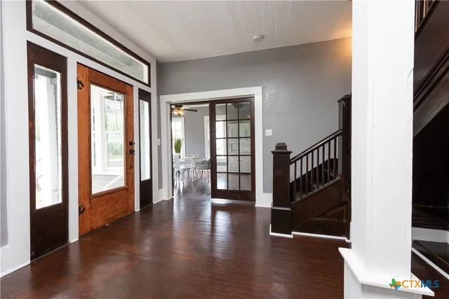 a view of an entryway with wooden floor