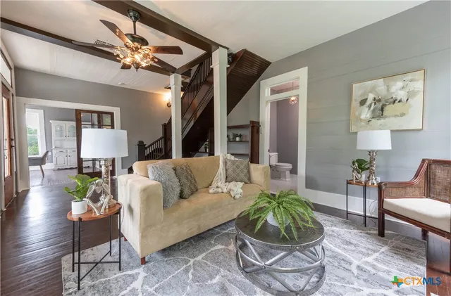 a living room with furniture and a chandelier