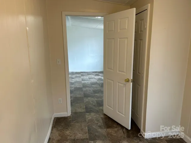 an empty room with windows and closet