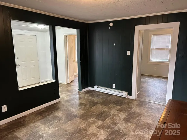 a view of a small space with wooden floor and a window