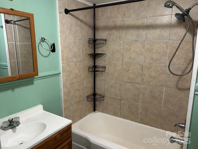 a bathroom with a bathtub and a shower