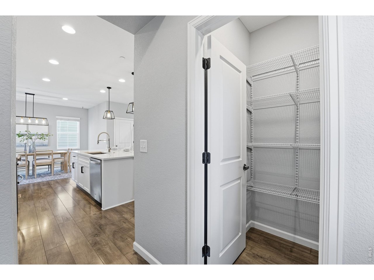 10094 Flower Street Broomfield, CO 80021 - Photo 11 of 40 a view of kitchen with refrigerator cabinets and wooden floor