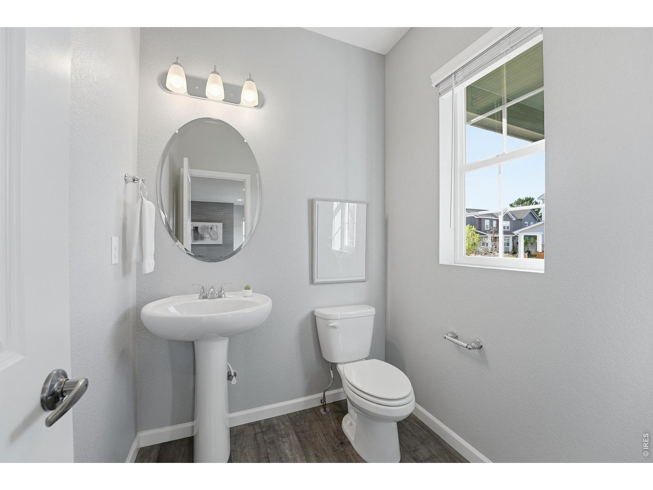 10094 Flower Street Broomfield, CO 80021 - Photo 14 of 40 a bathroom with a toilet sink and mirror
