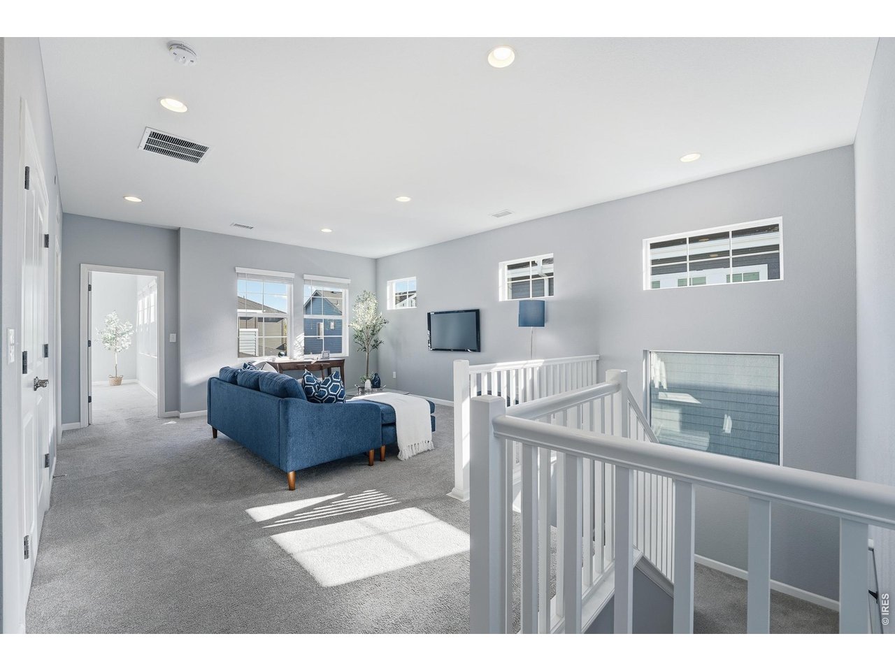 10094 Flower Street Broomfield, CO 80021 - Photo 16 of 40 a living room with furniture and a flat screen tv