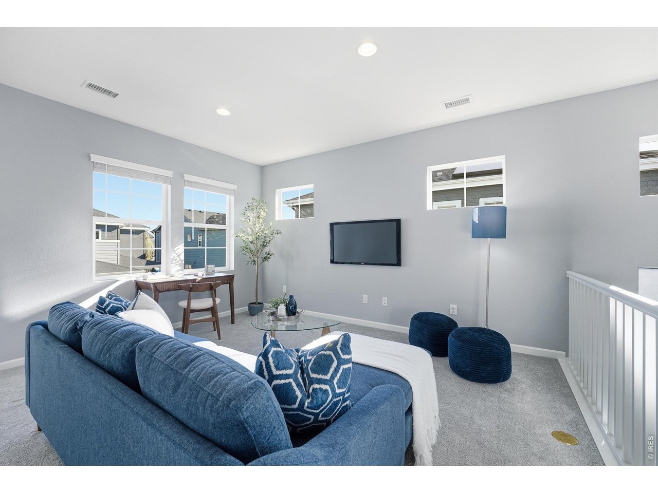 10094 Flower Street Broomfield, CO 80021 - Photo 17 of 40 a living room with furniture and a flat screen tv