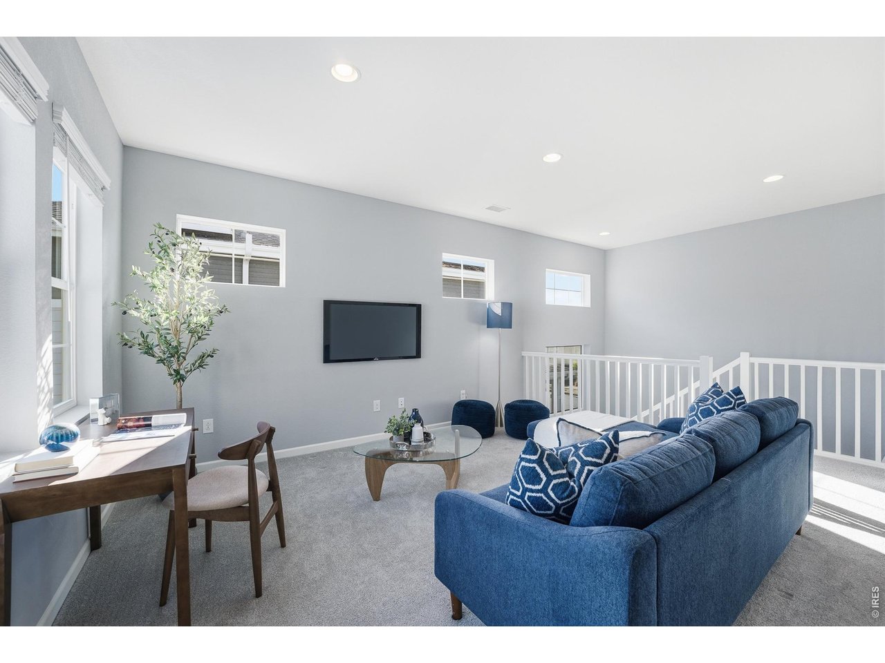 10094 Flower Street Broomfield, CO 80021 - Photo 18 of 40 a living room with furniture a flat screen tv and a window