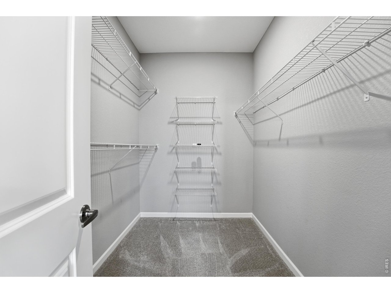 10094 Flower Street Broomfield, CO 80021 - Photo 25 of 40 a view of walk in closet with empty racks