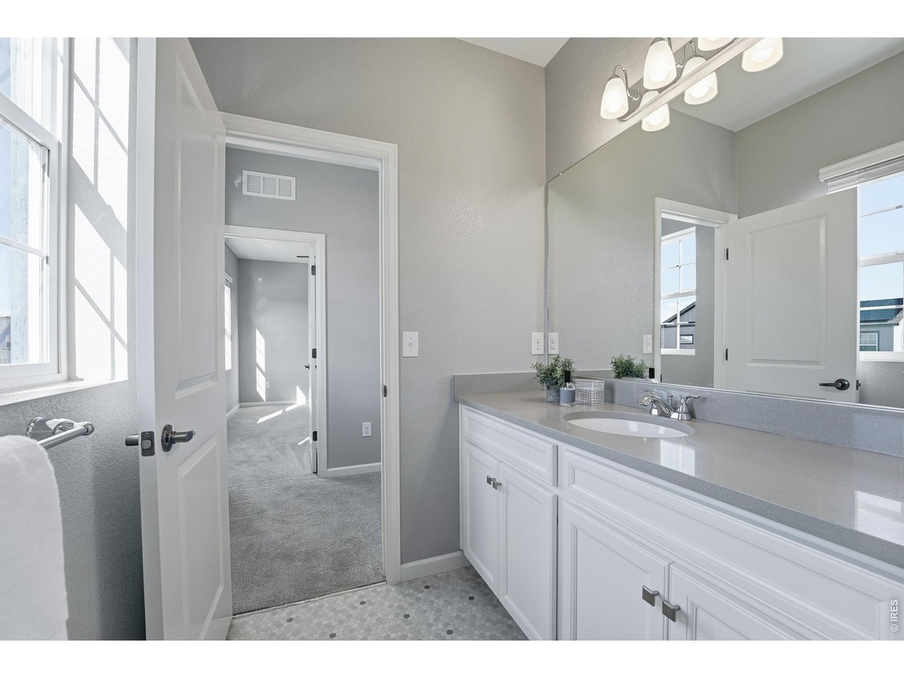 10094 Flower Street Broomfield, CO 80021 - Photo 30 of 40 a bathroom with a double vanity sink and a mirror