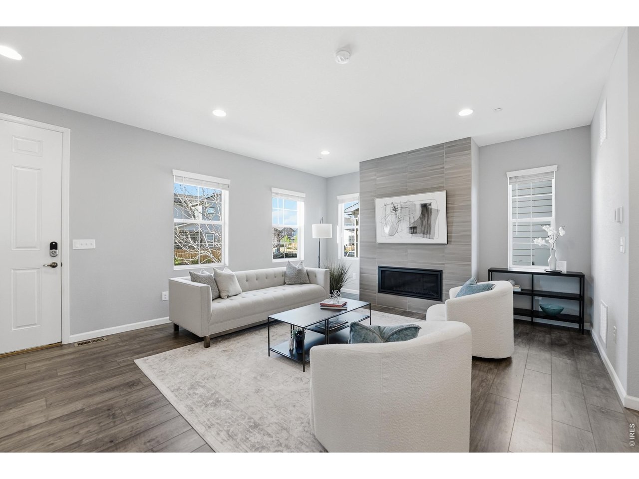 10094 Flower Street Broomfield, CO 80021 - Photo 6 of 40 a living room with furniture a fireplace and a window