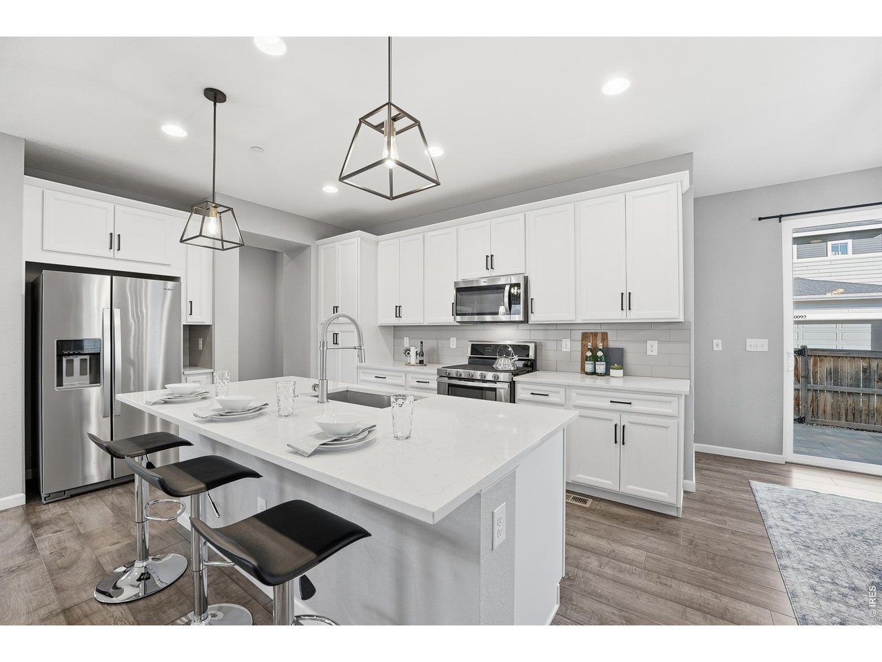 10094 Flower Street Broomfield, CO 80021 - Photo 8 of 40 a kitchen that has a lot of cabinets a sink and stainless steel appliances