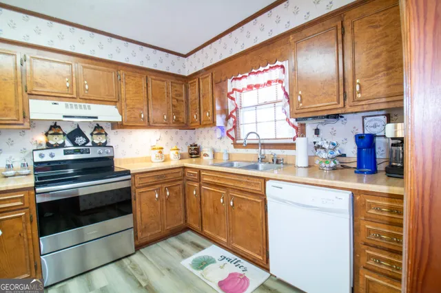 a kitchen with cabinets appliances and a window