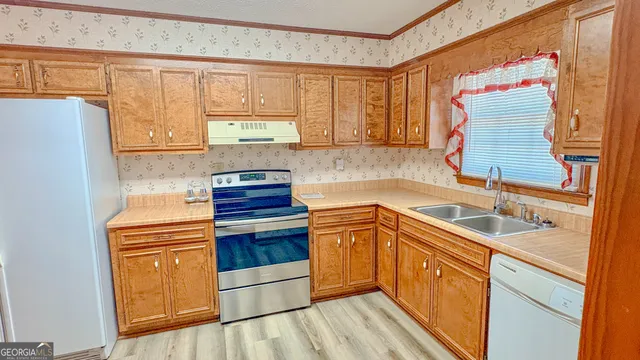 a kitchen with a sink stove and cabinets