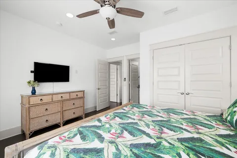 a bedroom with a bed and ceiling fan