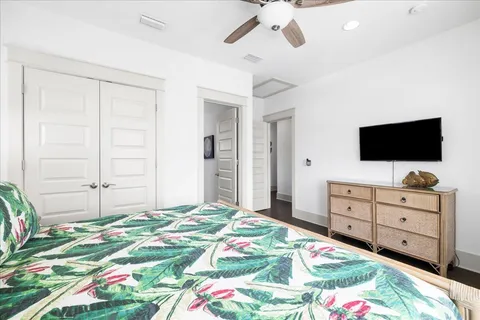 a bedroom with a bed and a flat screen tv in a dresser