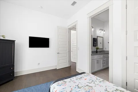 a bedroom with a bed and a television