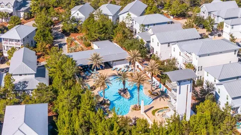 an aerial view of a house with a yard and outdoor seating