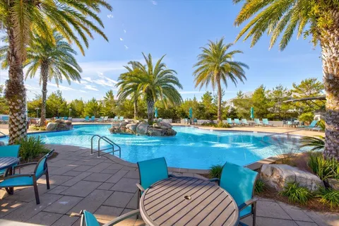 a view of swimming pool with a table and chairs