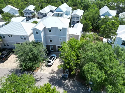 an aerial view of multiple houses with yard