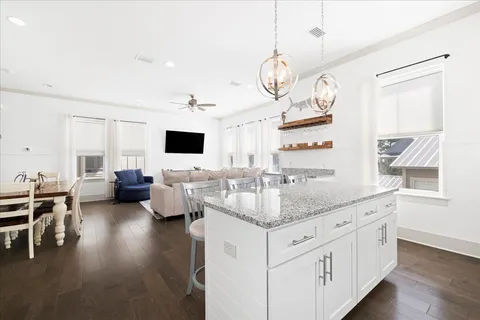 a kitchen with stainless steel appliances granite countertop a stove and white cabinets