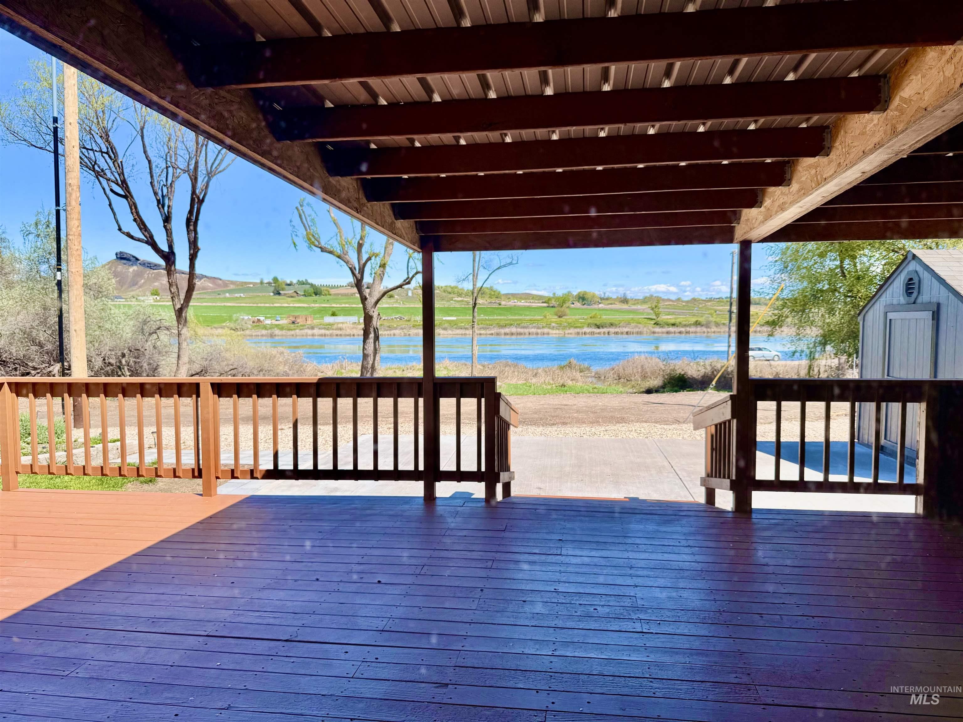 162 1st Street North Marsing, ID 83639 - Photo 26 of 39 Wooden deck featuring a storage unit and a water view