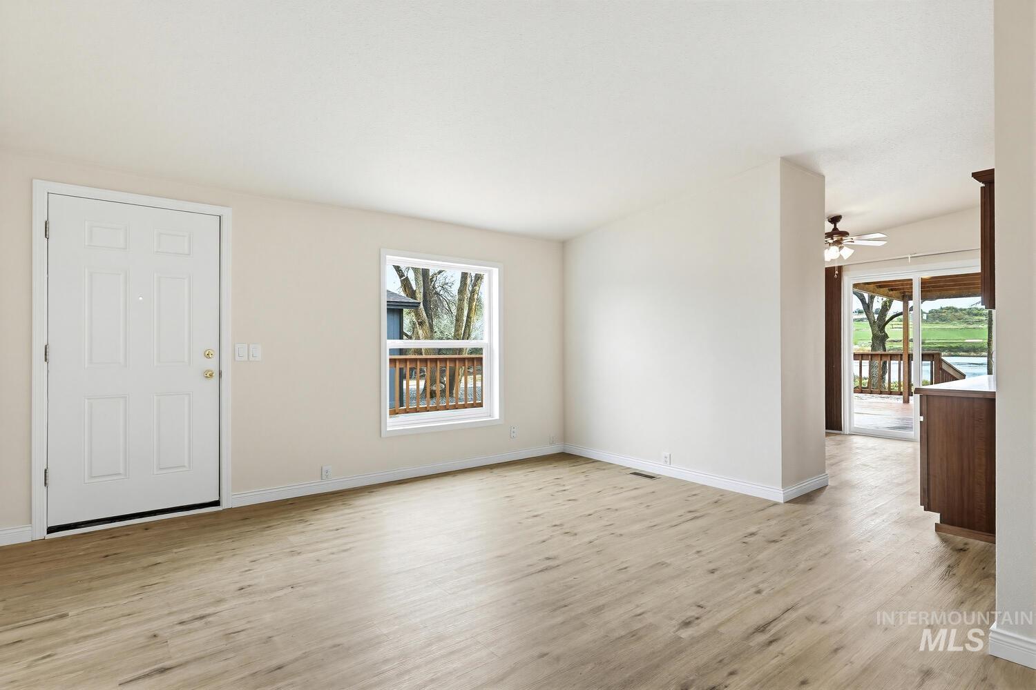162 1st Street North Marsing, ID 83639 - Photo 5 of 39 Unfurnished living room with light wood finished floors and a ceiling fan