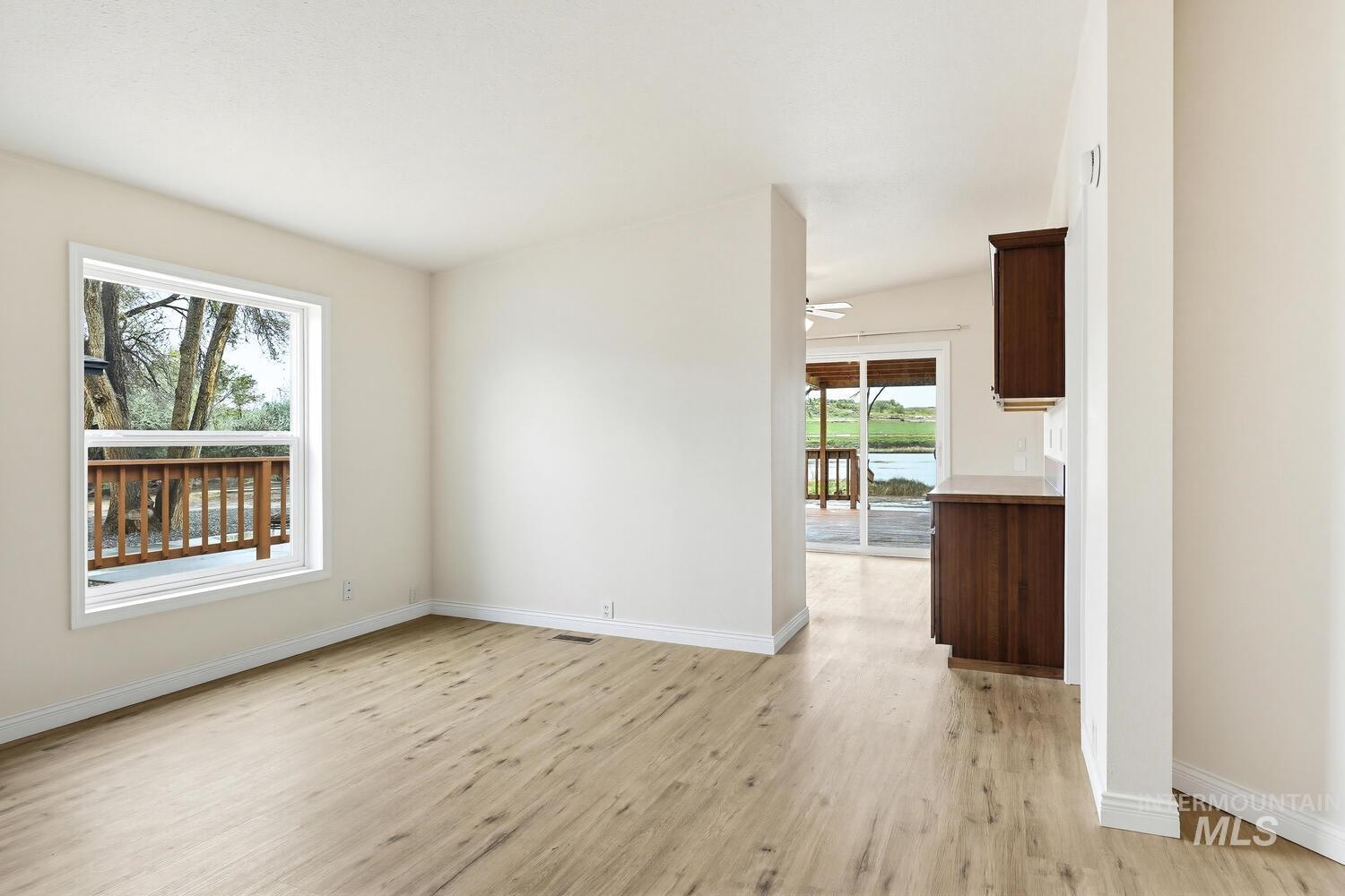 162 1st Street North Marsing, ID 83639 - Photo 9 of 39 Spare room featuring light wood-style floors, ceiling fan, and a water view