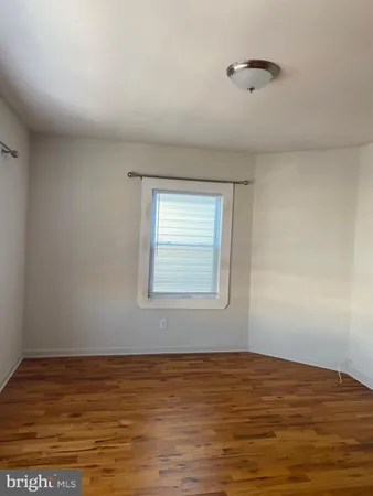 a view of an empty room and wooden floor
