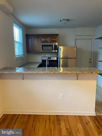 a view of kitchen cabinets and microwave