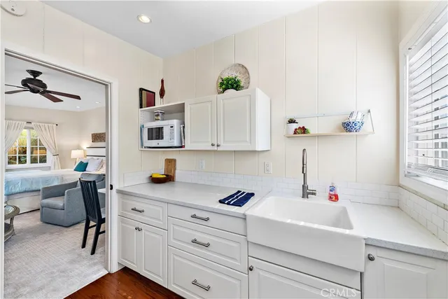 a kitchen with cabinets appliances and a window