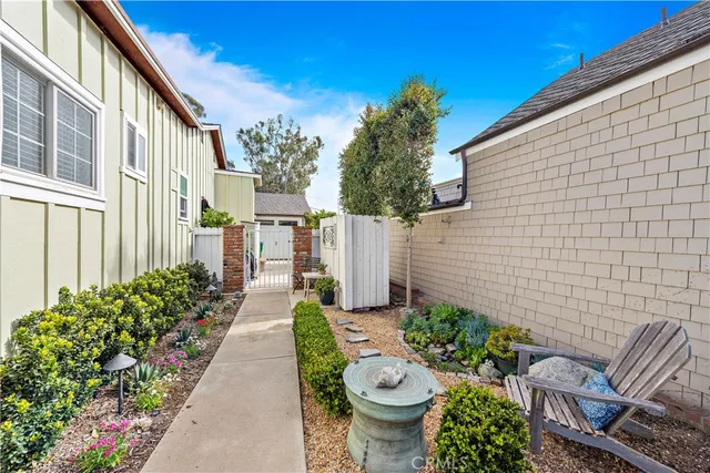 a view of a patio with chair and tables back yard of the house