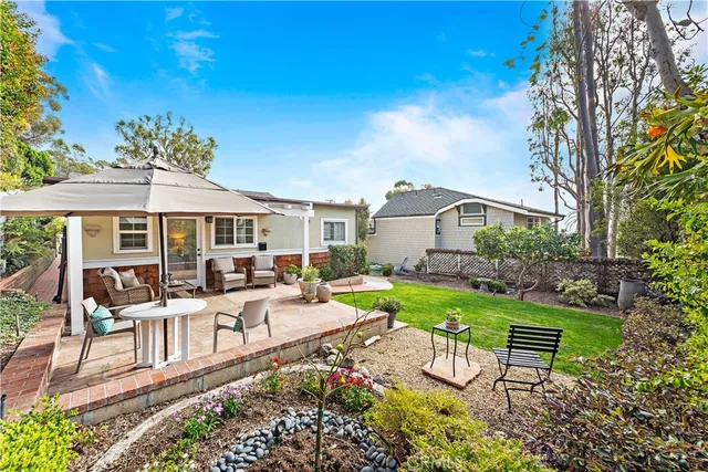 a view of a house with backyard porch and sitting area