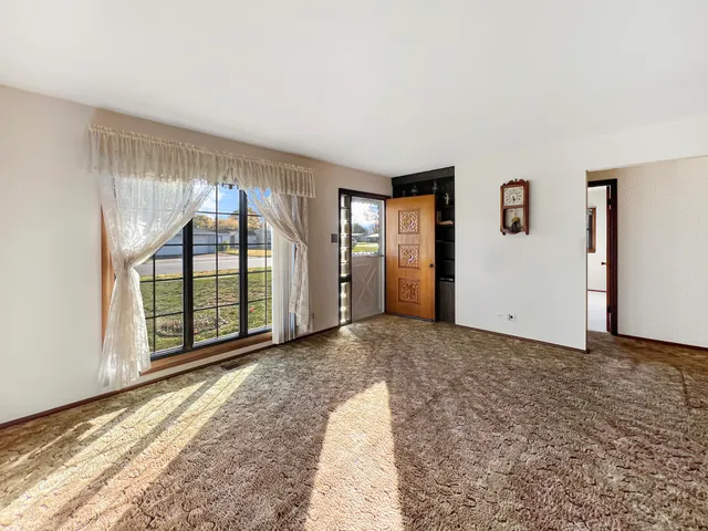 a view of empty room with floor to ceiling window
